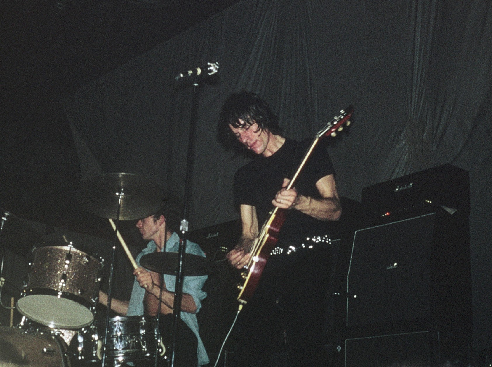 Jeff Beck performing live with a red Les Paul